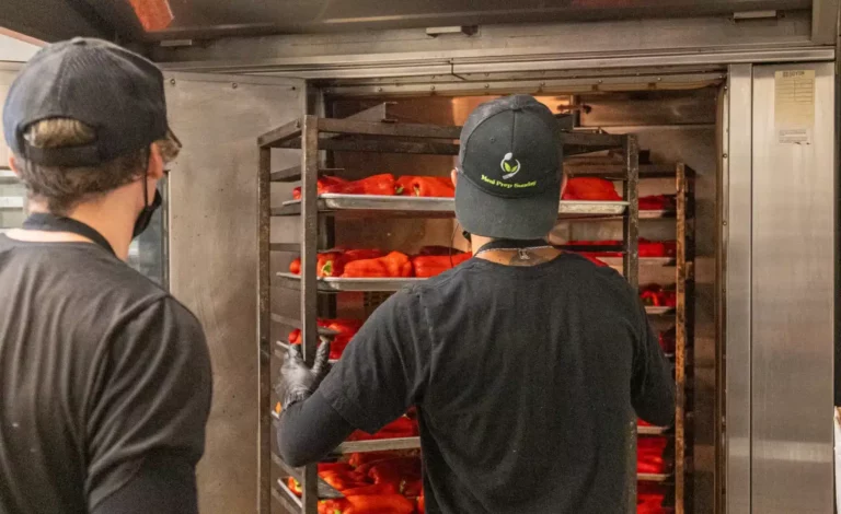 Chef preparing racks of fresh peppers – chef-crafted fitness meal prep