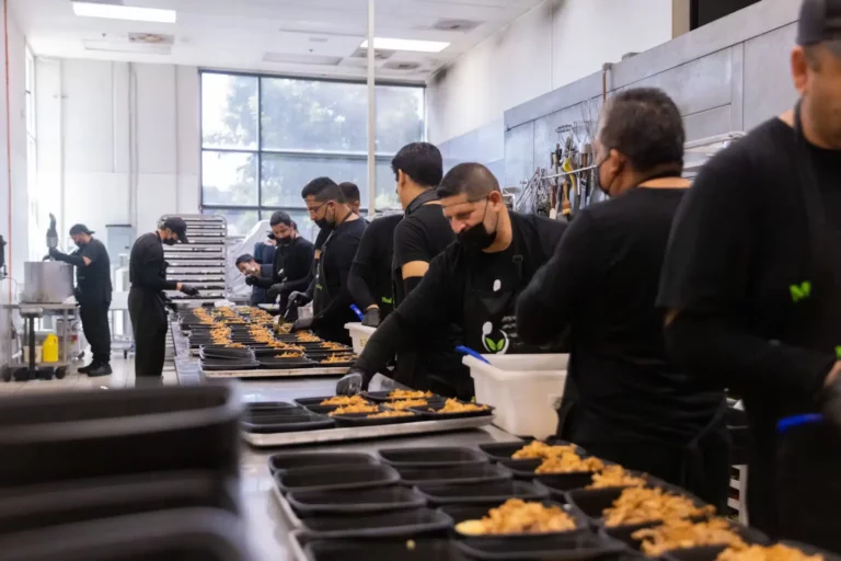 Meal prep line in action showing teamwork and culinary collaboration