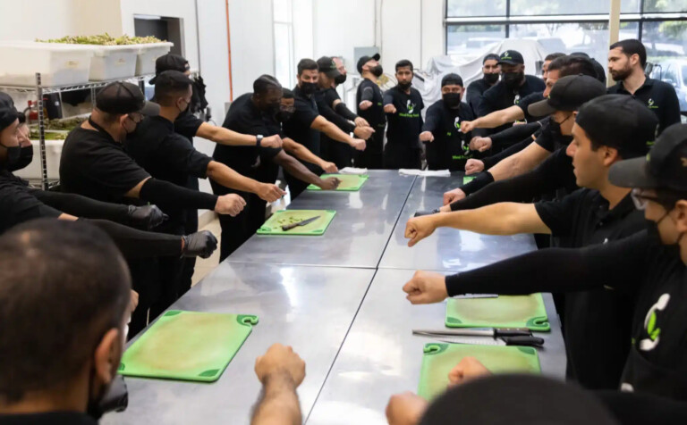 Meal Prep Sunday kitchen team meeting to review clean meal prep protocols.