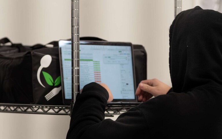 Logistics coordinator managing meal delivery routes for food prep efficiency.