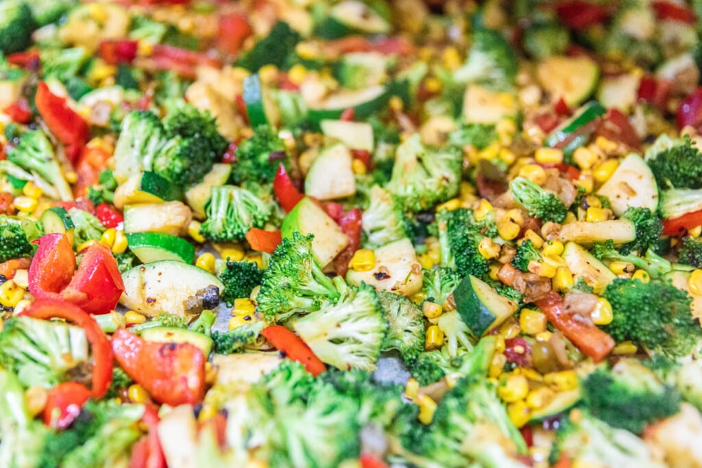 Colorful vegetables sizzling in skillet during steak meal prep