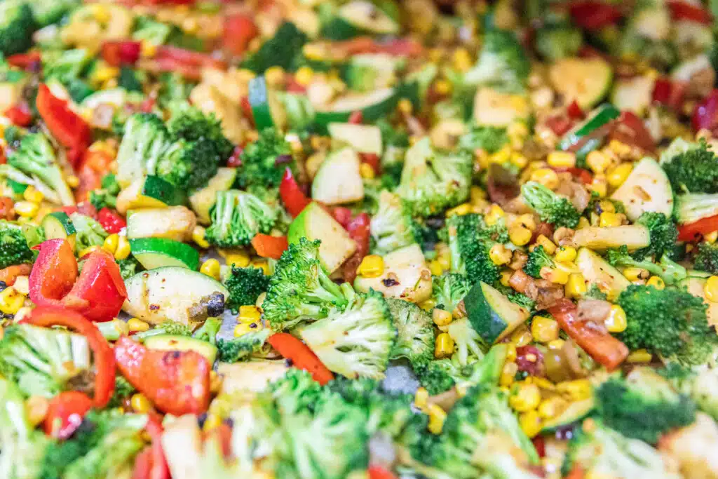 Colorful vegetables sizzling in skillet during steak meal prep