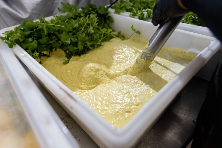 Avocado goddess sauce being stirred for how to cook chicken breast meal prep.