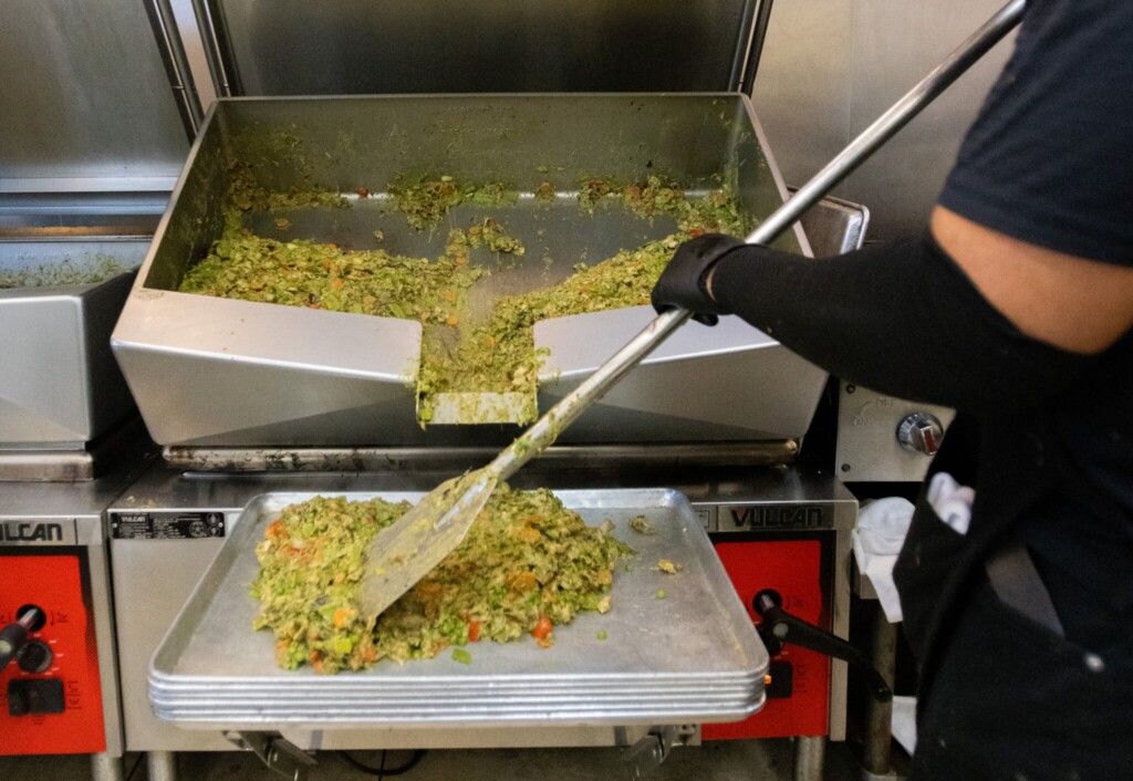 Avocado goddess sauce being stirred for how to cook chicken breast meal prep