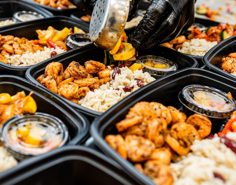 Shrimp meal prep being portioned into Meal Prep Sunday containers