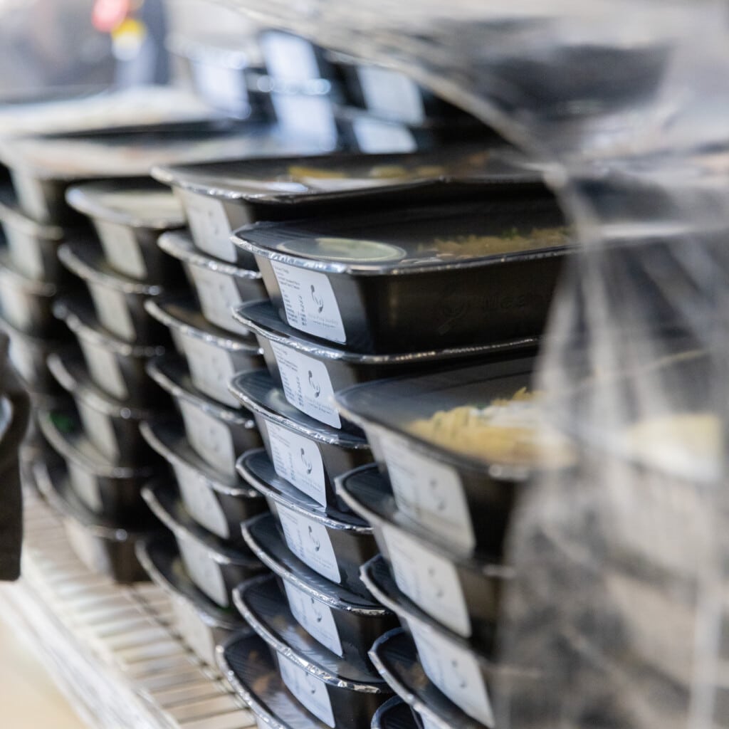 Freshly prepared meals stored in industrial fridge for safe delivery