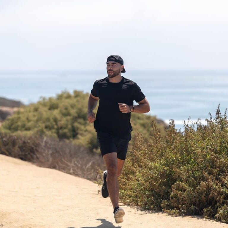 Influencer running to reach fitness goals during morning workout