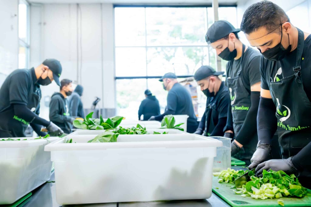 Culinary team chopping fresh lettuce for nutrient-rich high-quality meal prep