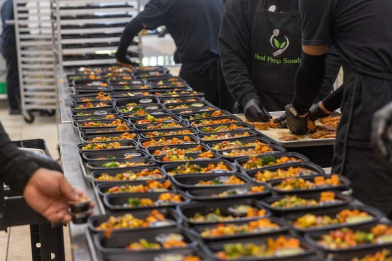 Meal Prep Sunday chefs assembling fresh, pre-portioned meals in a commercial kitchen