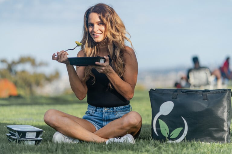 Smiling woman enjoying a healthy Meal Prep Sunday dish at home