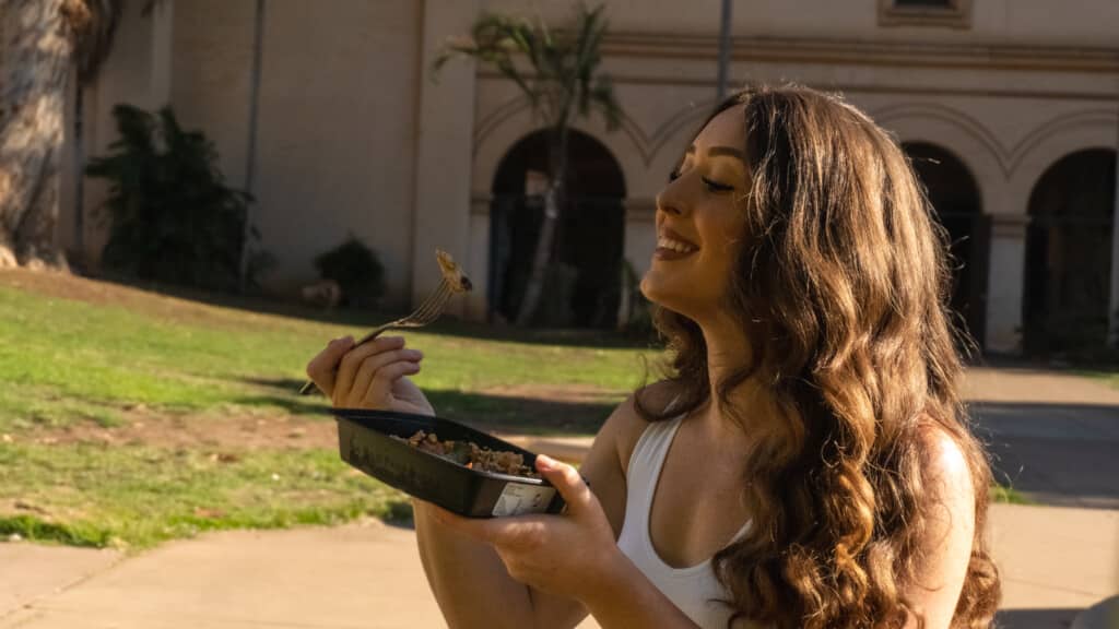 Influencer enjoying a delicious Meal Prep Sunday healthy meal on the go