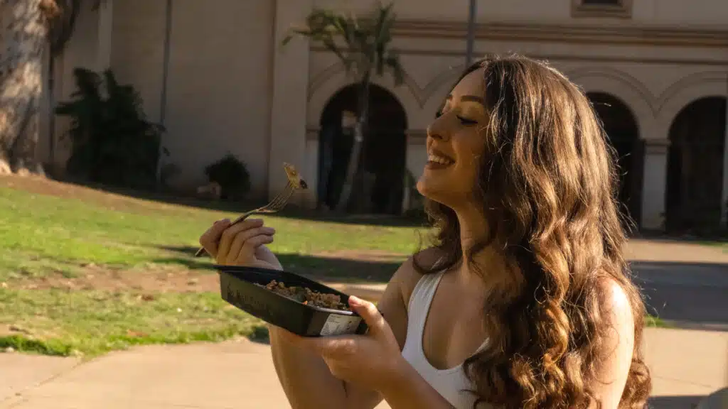 Influencer enjoying a delicious Meal Prep Sunday healthy meal on the go