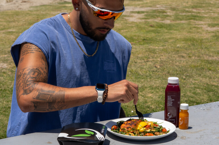 Influencer enjoying sunset with meal prep.