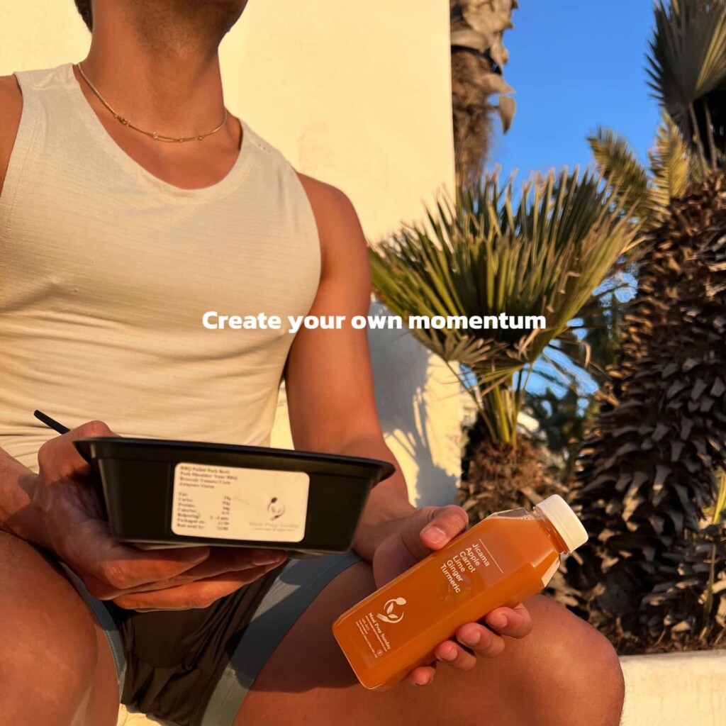 Influencer enjoying sunset with meal prep.