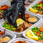 Ready to eat meals from Meal Prep Sunday: steak, asparagus, and sweet potato containers finished by hand with lemon wedges