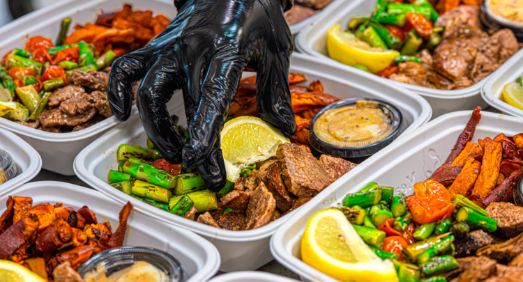 Ready to eat meals from Meal Prep Sunday: steak, asparagus, and sweet potato containers finished by hand with lemon wedges